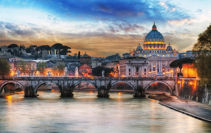 St. Petersdom und Brücke über den Tiber bei Sonnenuntergang in Rom.